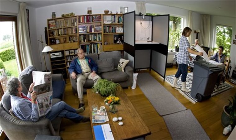A woman casts her vote at a polling station set up in the the living room of the Westhoff family in Marle, eastern Netherlands, on Wednesday. The small community's polling station has been in their living room since the 1948 elections.